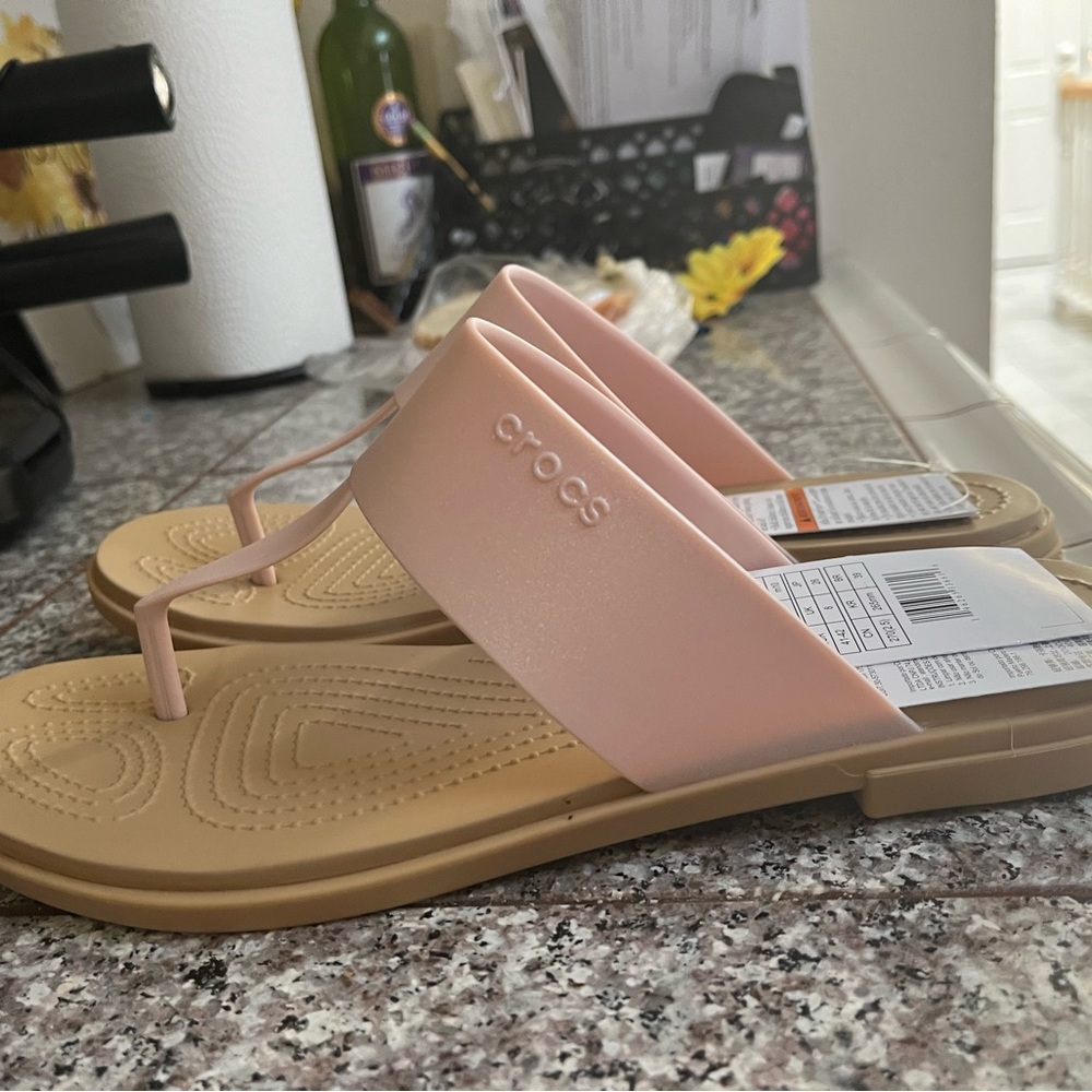 Brand new never been worn, light pink crocs flip-flops.